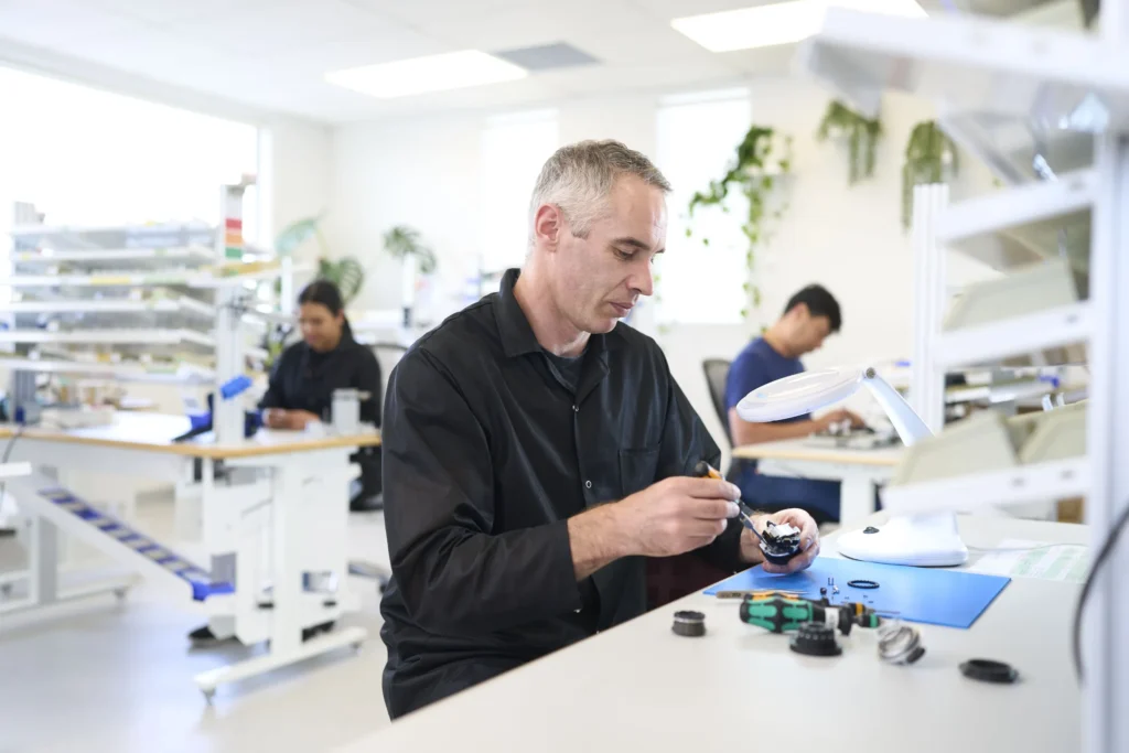 A TASKA technician servicing a hand