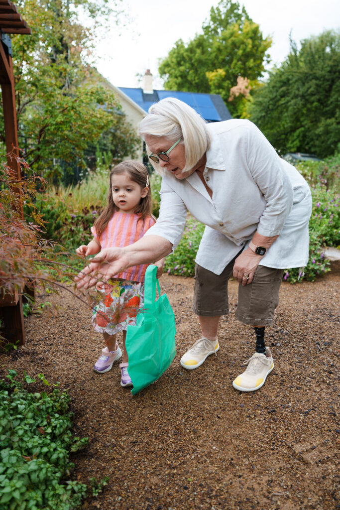 Elderly woman wearing Traverse K2 with child in a garden