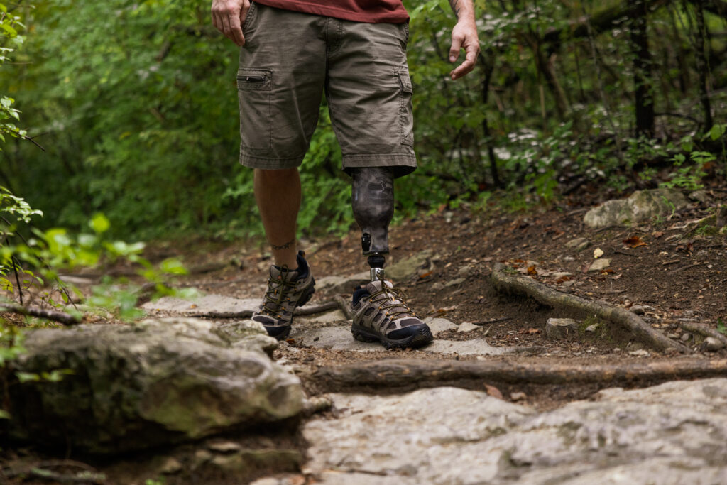 Man walking with Traverse AV on a rugged trail.